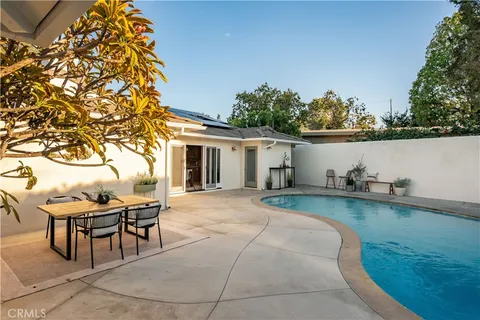 an aerial view of a house with a yard and a patio