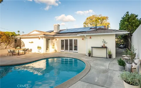 an aerial view of a house with a swimming pool patio and outdoor seating