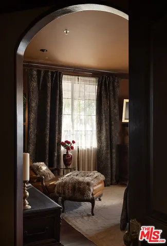 a bedroom with a bed and large windows