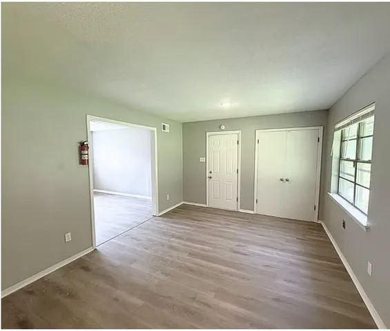 wooden floor in an empty room with a window