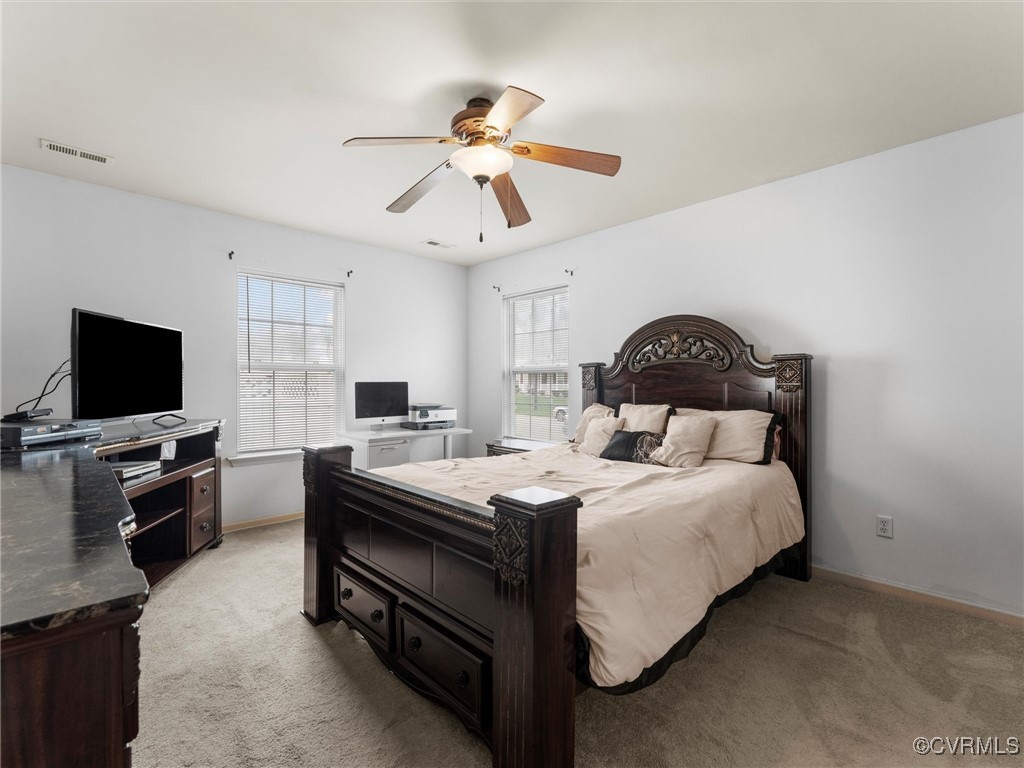 Bedroom featuring light carpet and a ceiling fan