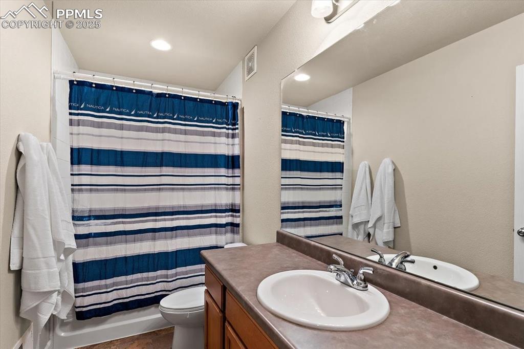 7890 Treehouse Terrace Fountain, CO 80817 - Photo 27 of 31 a bathroom with a sink a toilet and a mirror