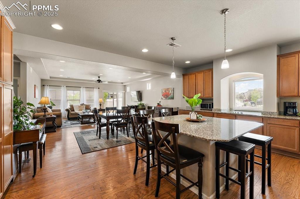 7890 Treehouse Terrace Fountain, CO 80817 - Photo 3 of 31 a large kitchen with lots of furniture a sink appliances and a dining table