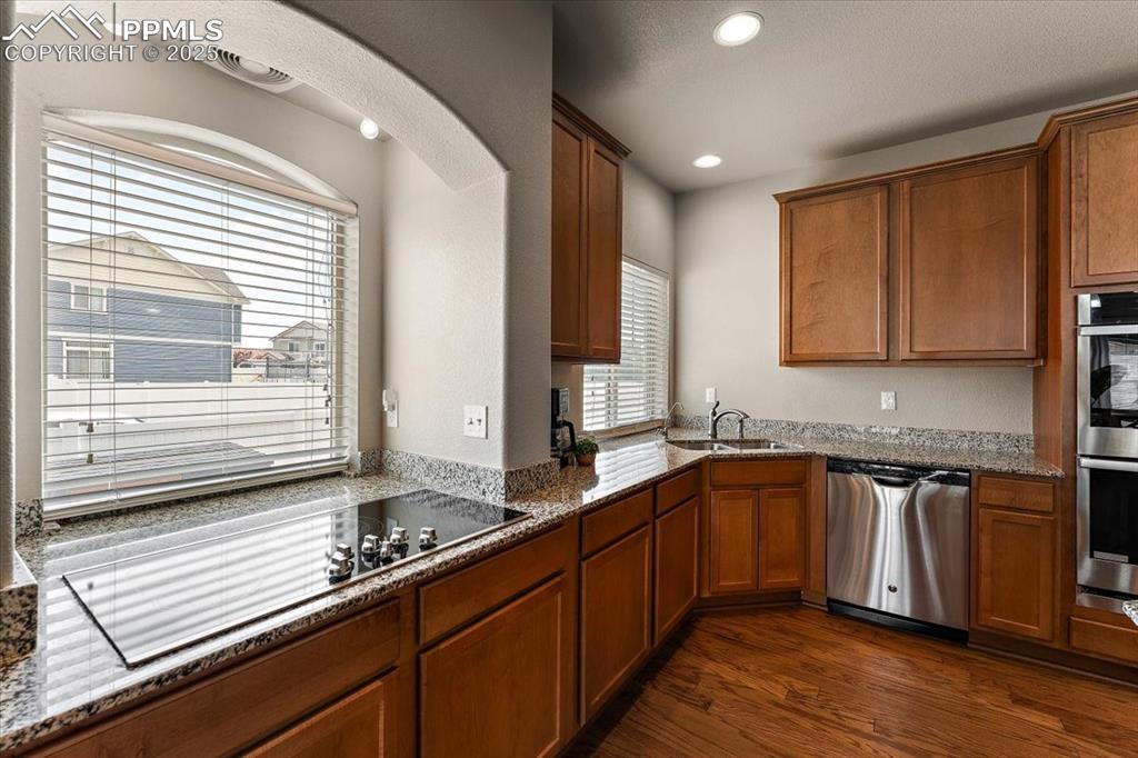 7890 Treehouse Terrace Fountain, CO 80817 - Photo 6 of 31 a kitchen with stainless steel appliances sink cabinets and window