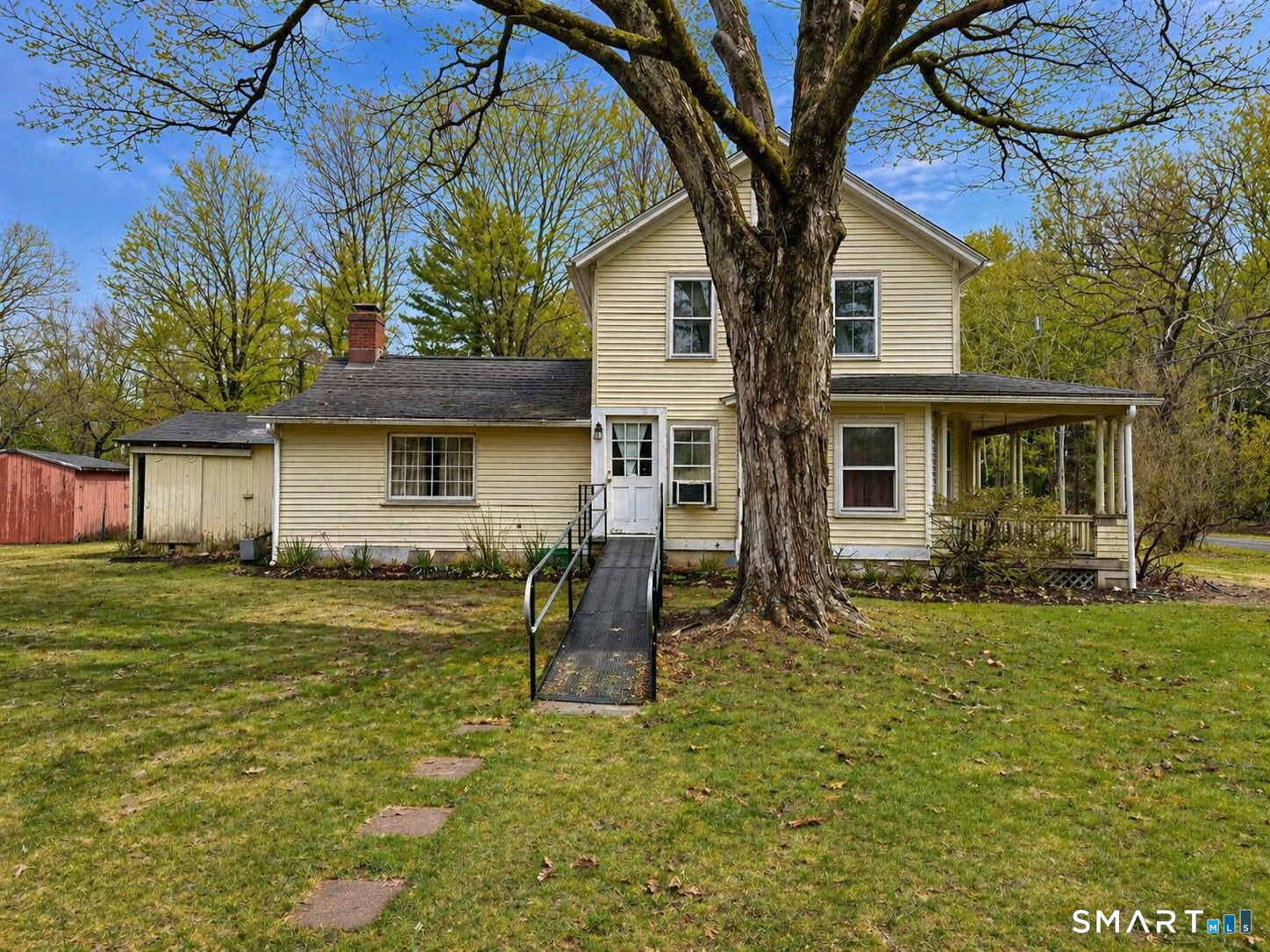 21 High Bridge Road Newtown, CT 06482 - Photo 3 of 14 a front view of a house with a garden