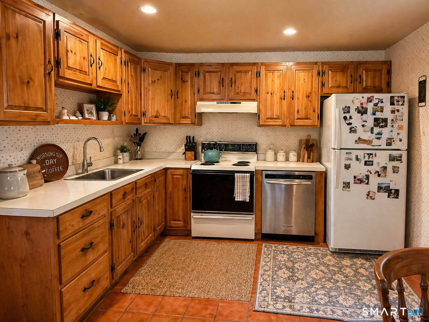 21 High Bridge Road Newtown, CT 06482 - Photo 7 of 14 a kitchen with stainless steel appliances a sink a stove a refrigerator cabinets and a window