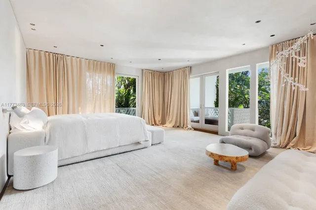 a bedroom with furniture and a large window