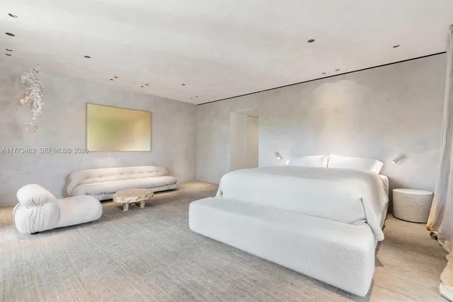 a bedroom with a bed and a couch