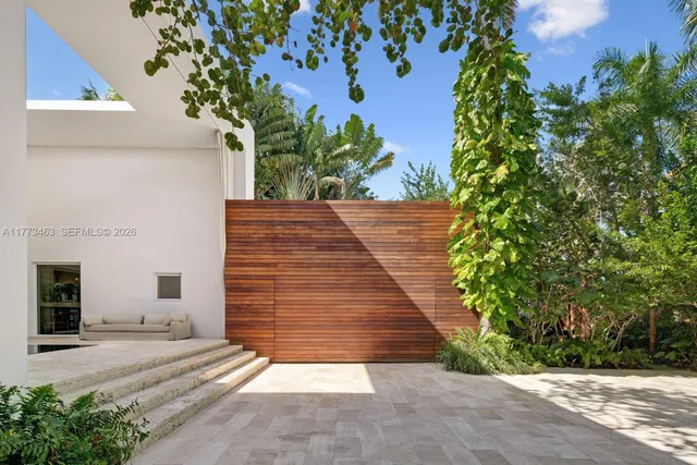 a view of a house with pool and chairs