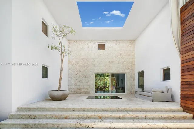 a view of a livingroom with furniture and staircase
