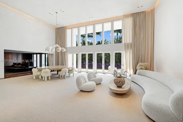 a bedroom with furniture and a large window