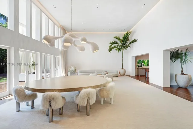 a dining room with furniture and a potted plant