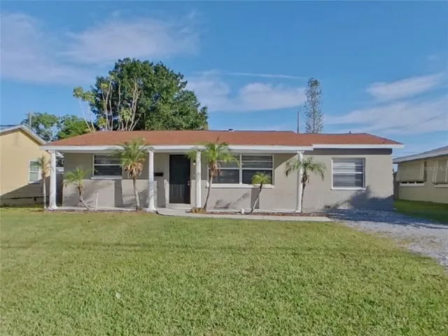 a front view of a house with a yard and porch