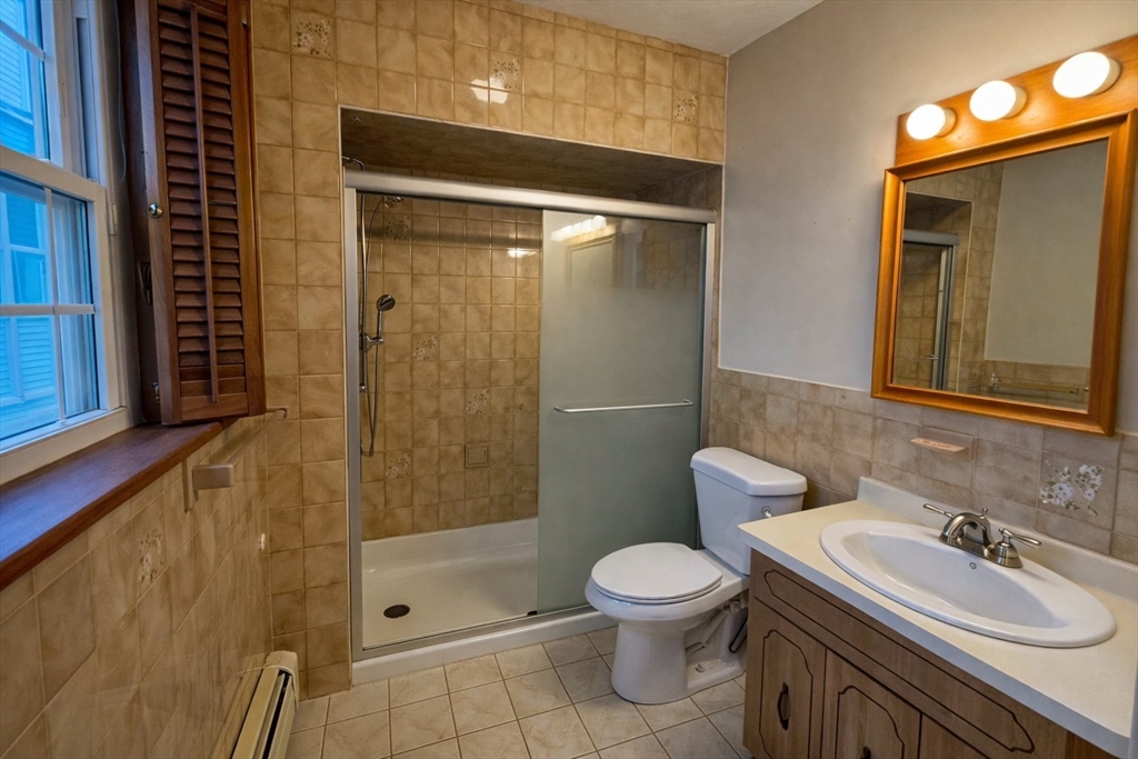 198 Washington Street, Unit 1 Somerville, MA 02143 - Photo 12 of 15 a bathroom with a sink a toilet and shower