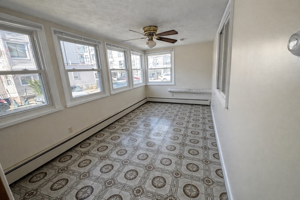 198 Washington Street, Unit 1 Somerville, MA 02143 - Photo 3 of 15 wooden floor in an empty room with a window