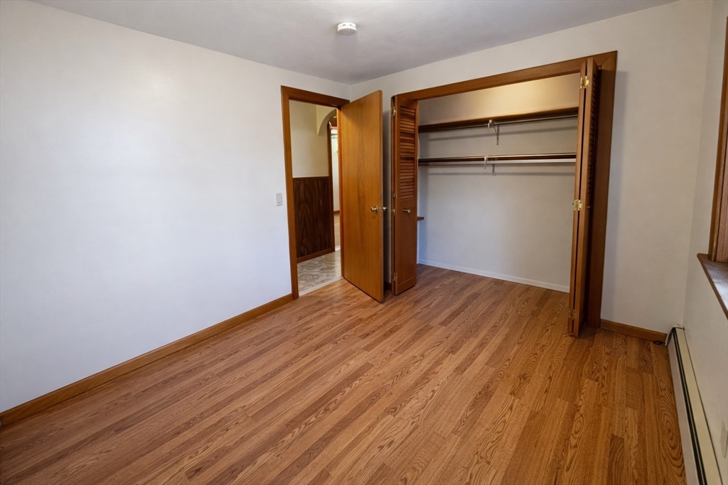 198 Washington Street, Unit 1 Somerville, MA 02143 - Photo 9 of 15 a view of an empty room with wooden floor and a window