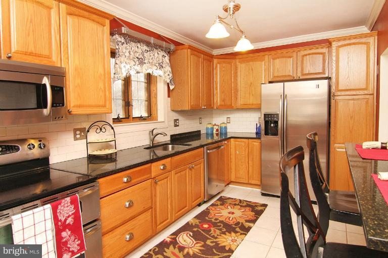 330 Hopkins Road Baltimore, MD 21212 - Photo 20 of 30 a kitchen with stainless steel appliances granite countertop a refrigerator sink and cabinets