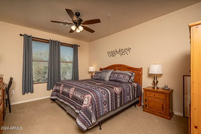 a bedroom with a bed and a large window