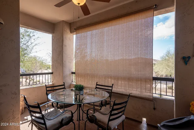 a view of a dining room with furniture and window