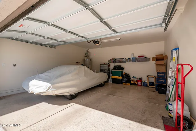 a bedroom with bed and a large window