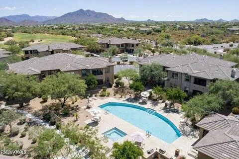 an aerial view of residential houses and outdoor space