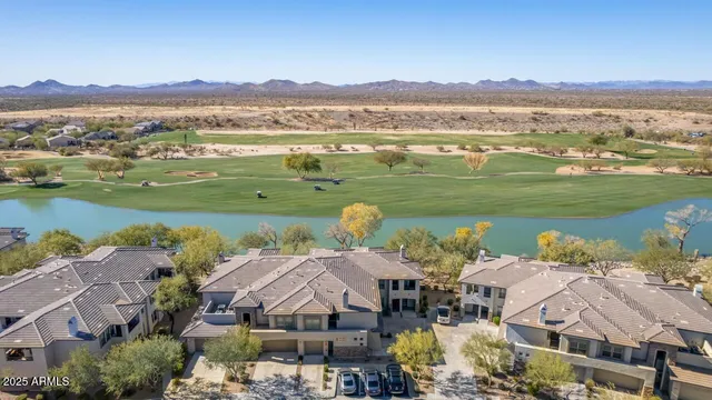 an aerial view of a houses with a lake view