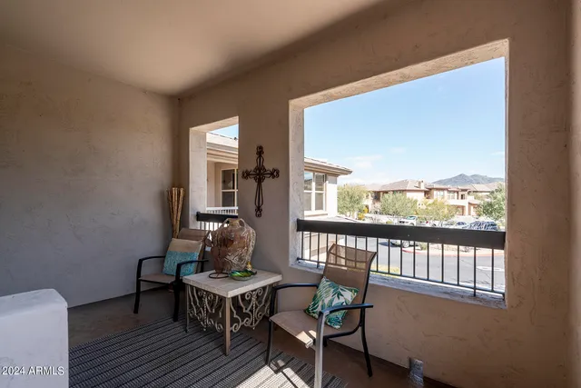 a balcony with furniture and a window