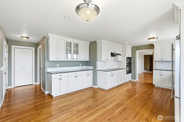 a kitchen with stainless steel appliances granite countertop a stove a microwave and cabinets
