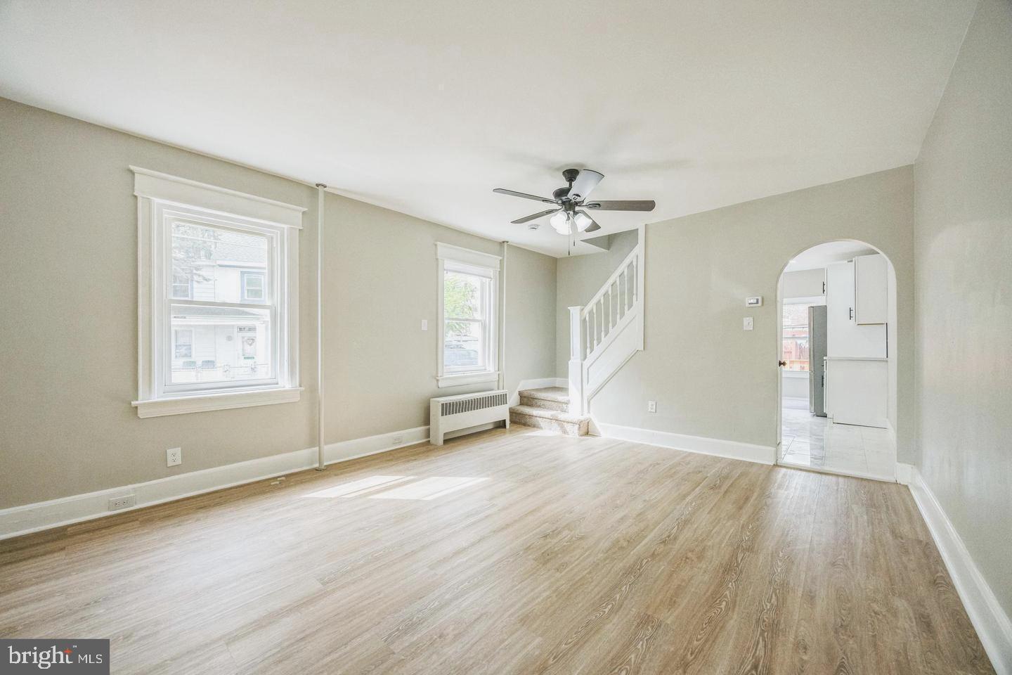 131 Columbus Avenue Trenton, NJ 08629 - Photo 2 of 12 an empty room with wooden floor and windows