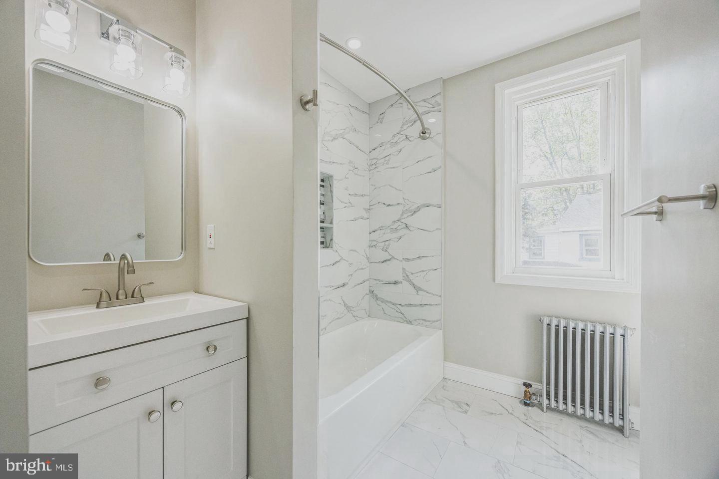 131 Columbus Avenue Trenton, NJ 08629 - Photo 9 of 12 a bathroom with a sink a toilet and shower