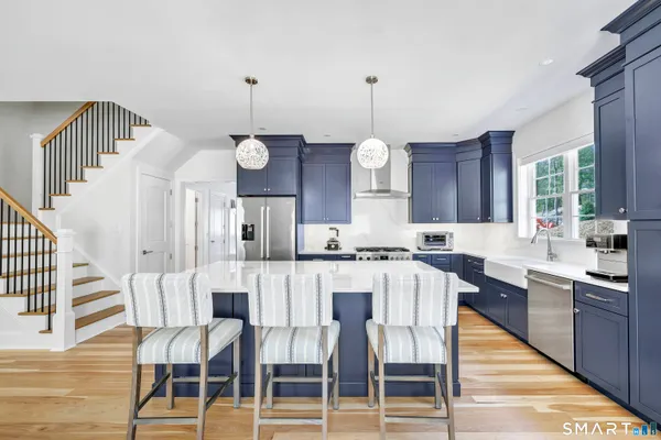 a large kitchen with a table and chairs
