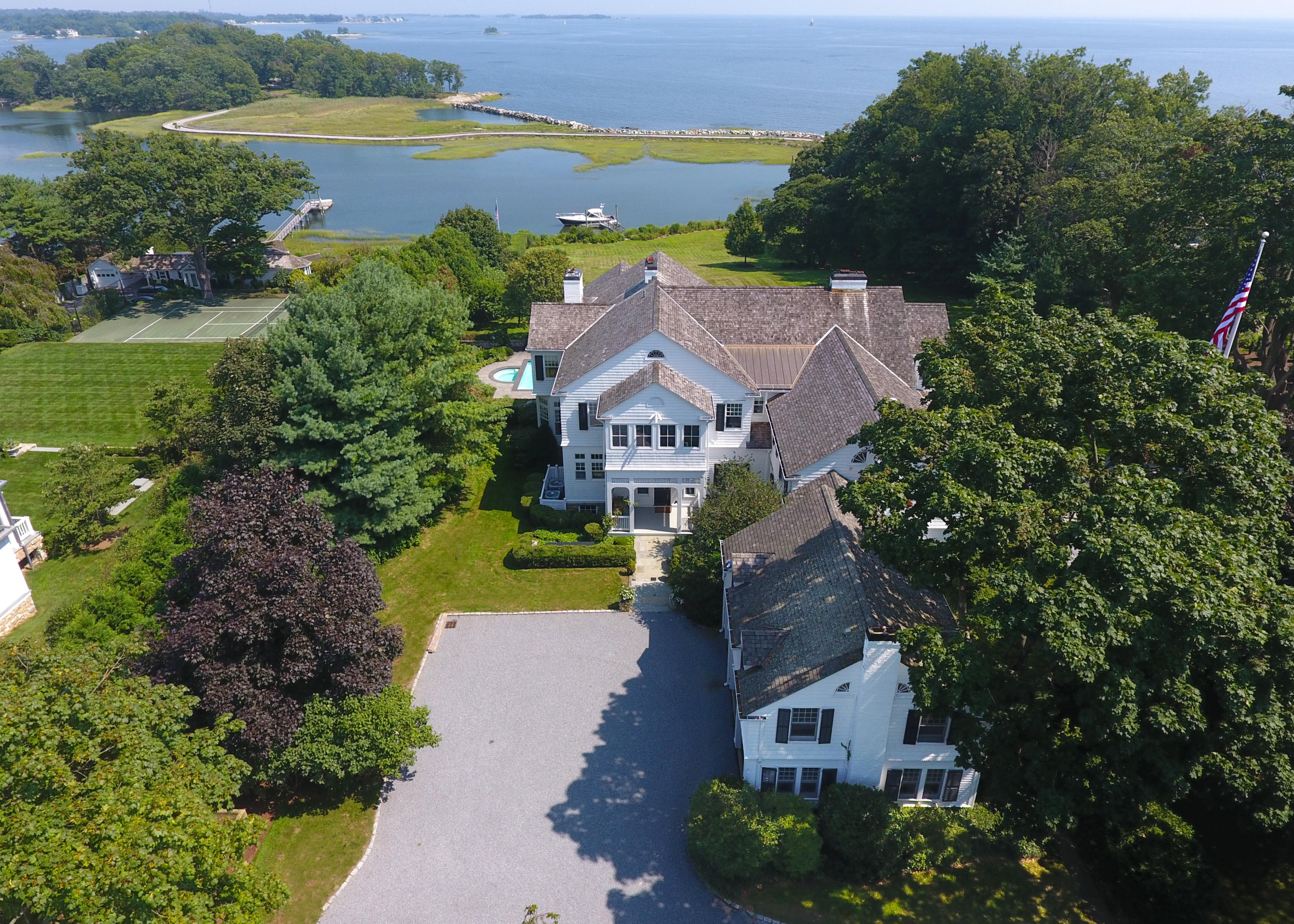 155 Long Neck Point Road Darien, CT 06820 - Photo 2 of 52 an aerial view of a house with a garden and lake view