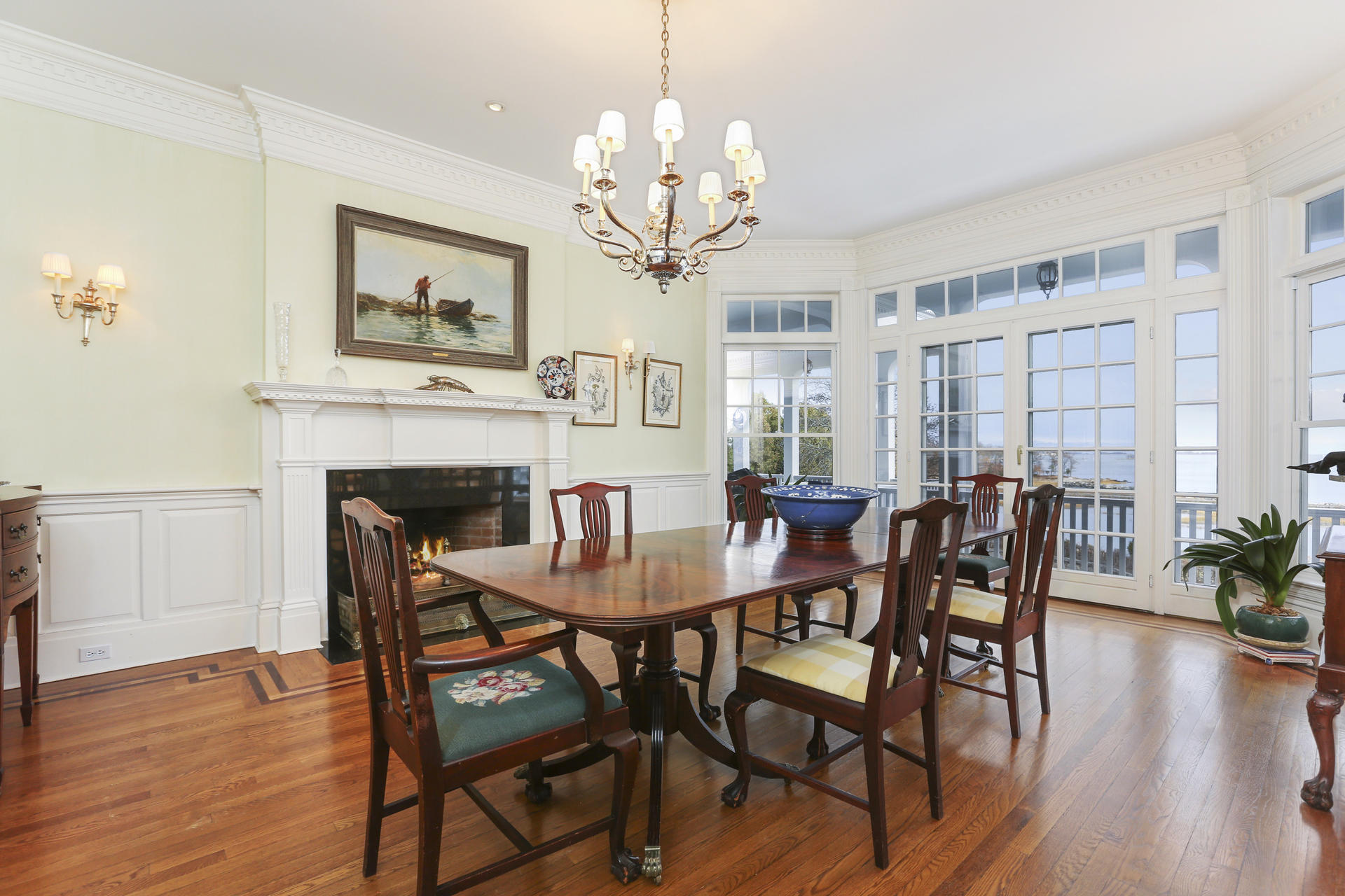 155 Long Neck Point Road Darien, CT 06820 - Photo 16 of 52 a dining room with furniture a chandelier and wooden floor