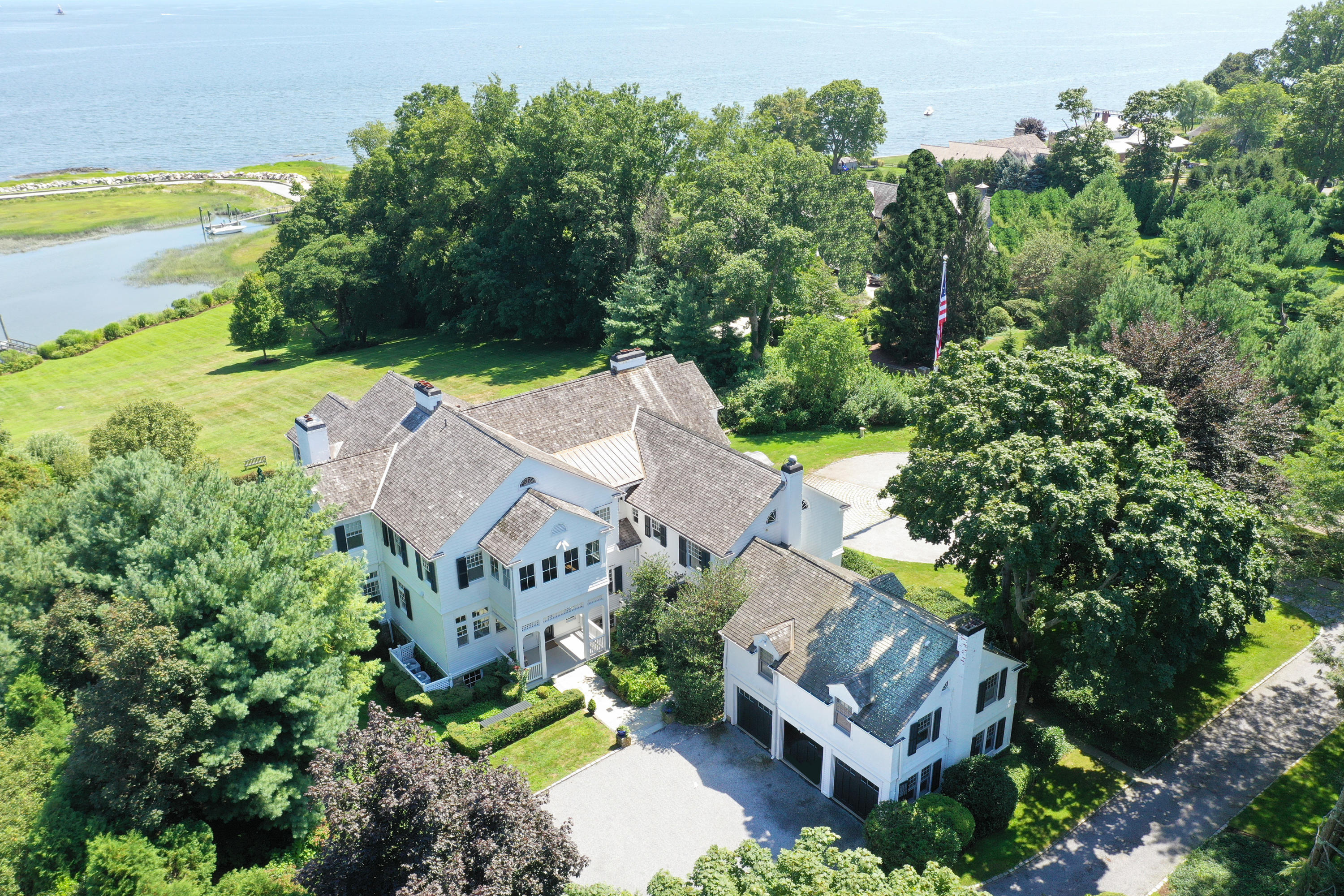 155 Long Neck Point Road Darien, CT 06820 - Photo 3 of 52 an aerial view of a house with a garden and lake view