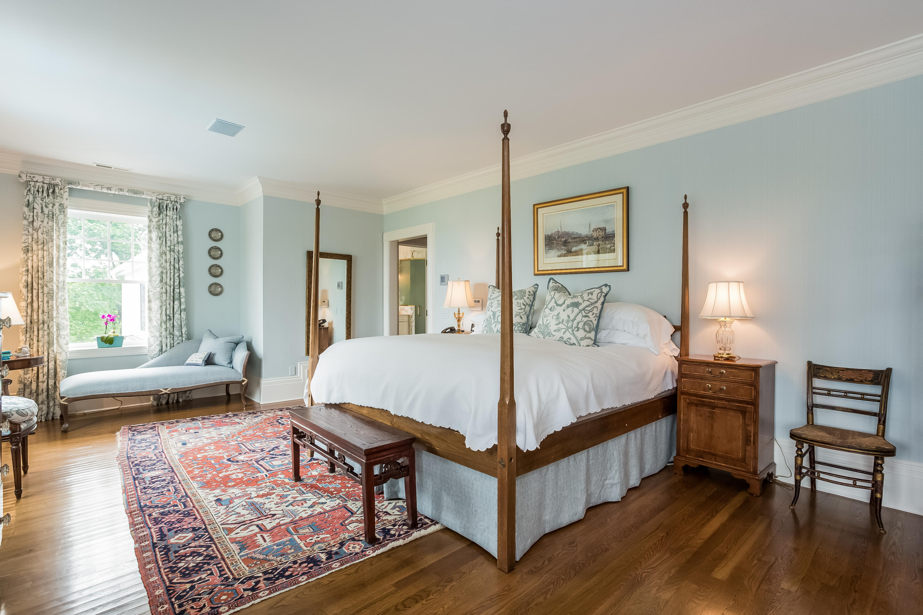 155 Long Neck Point Road Darien, CT 06820 - Photo 23 of 52 a spacious bedroom with a bed a table and a dresser