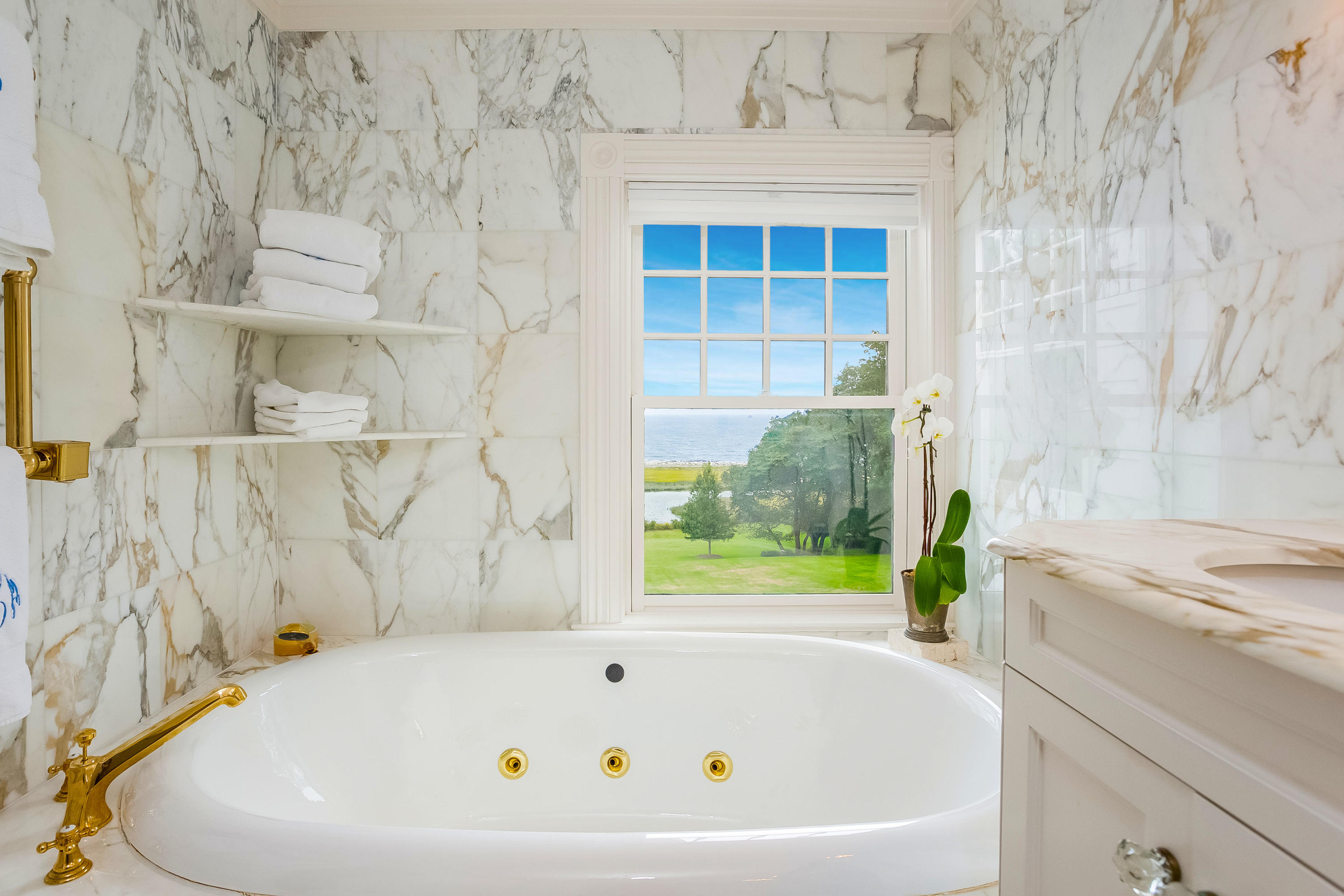 155 Long Neck Point Road Darien, CT 06820 - Photo 27 of 52 a white bath tub sitting next to a window