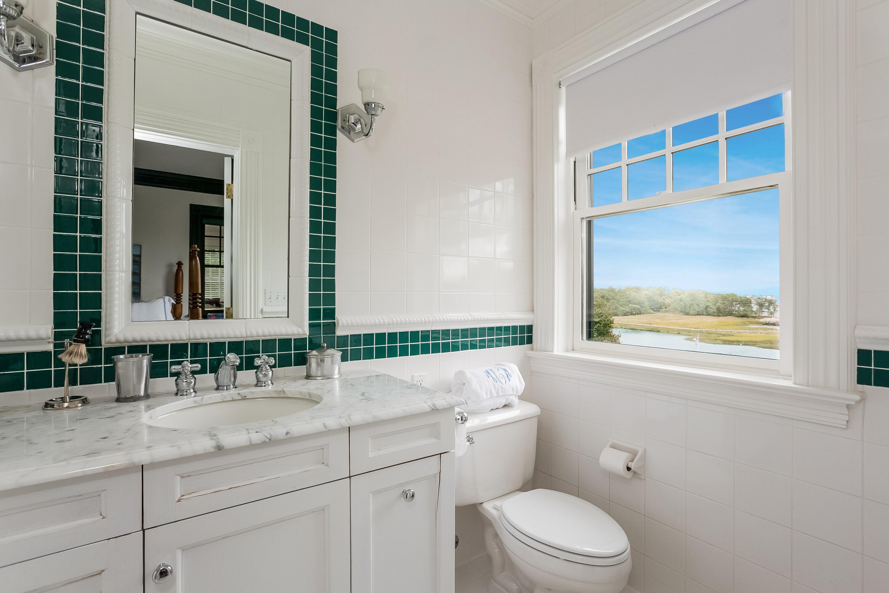155 Long Neck Point Road Darien, CT 06820 - Photo 29 of 52 a bathroom with a granite countertop toilet a sink a mirror and a window