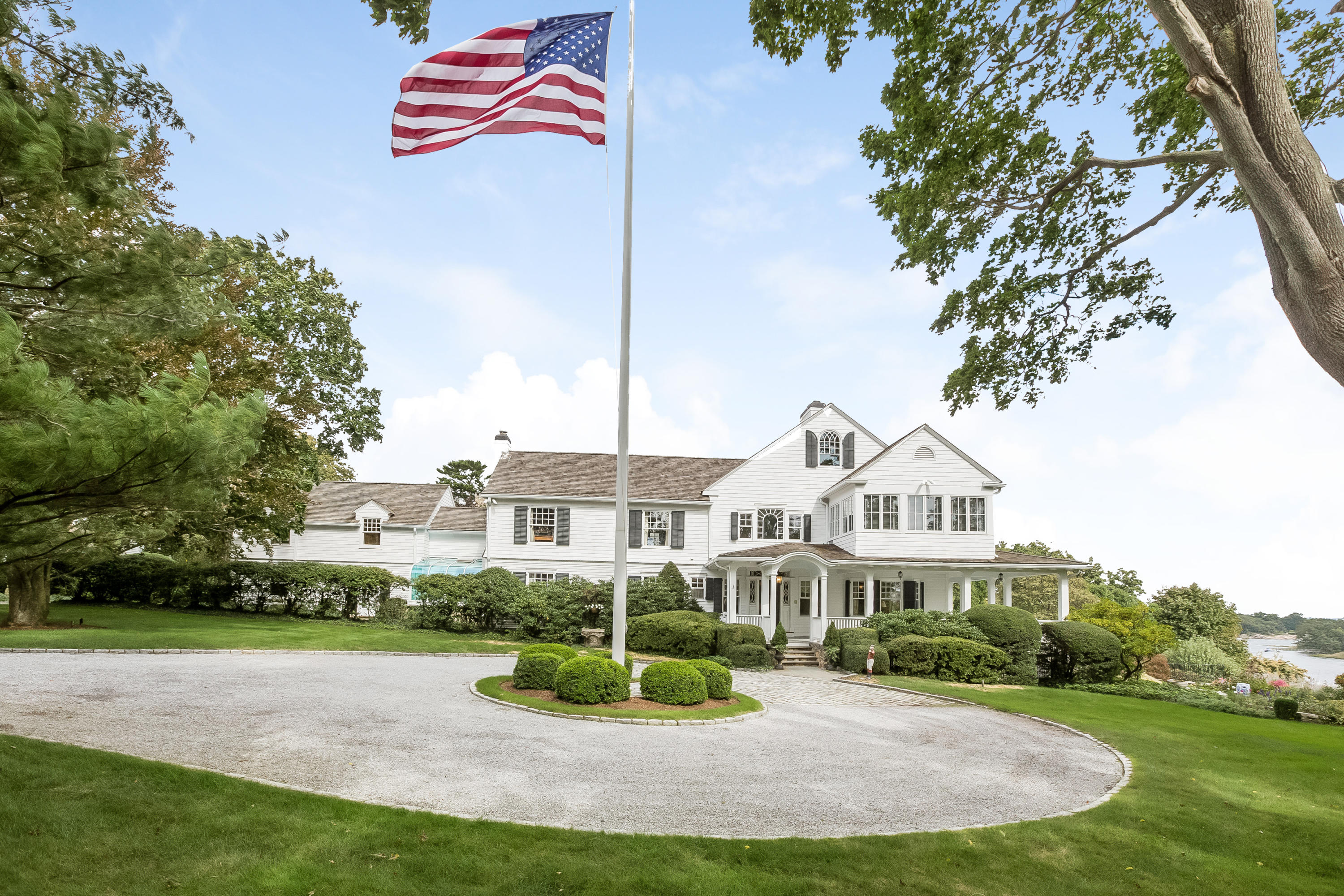 155 Long Neck Point Road Darien, CT 06820 - Photo 4 of 52 a view of a house with a yard and potted plants