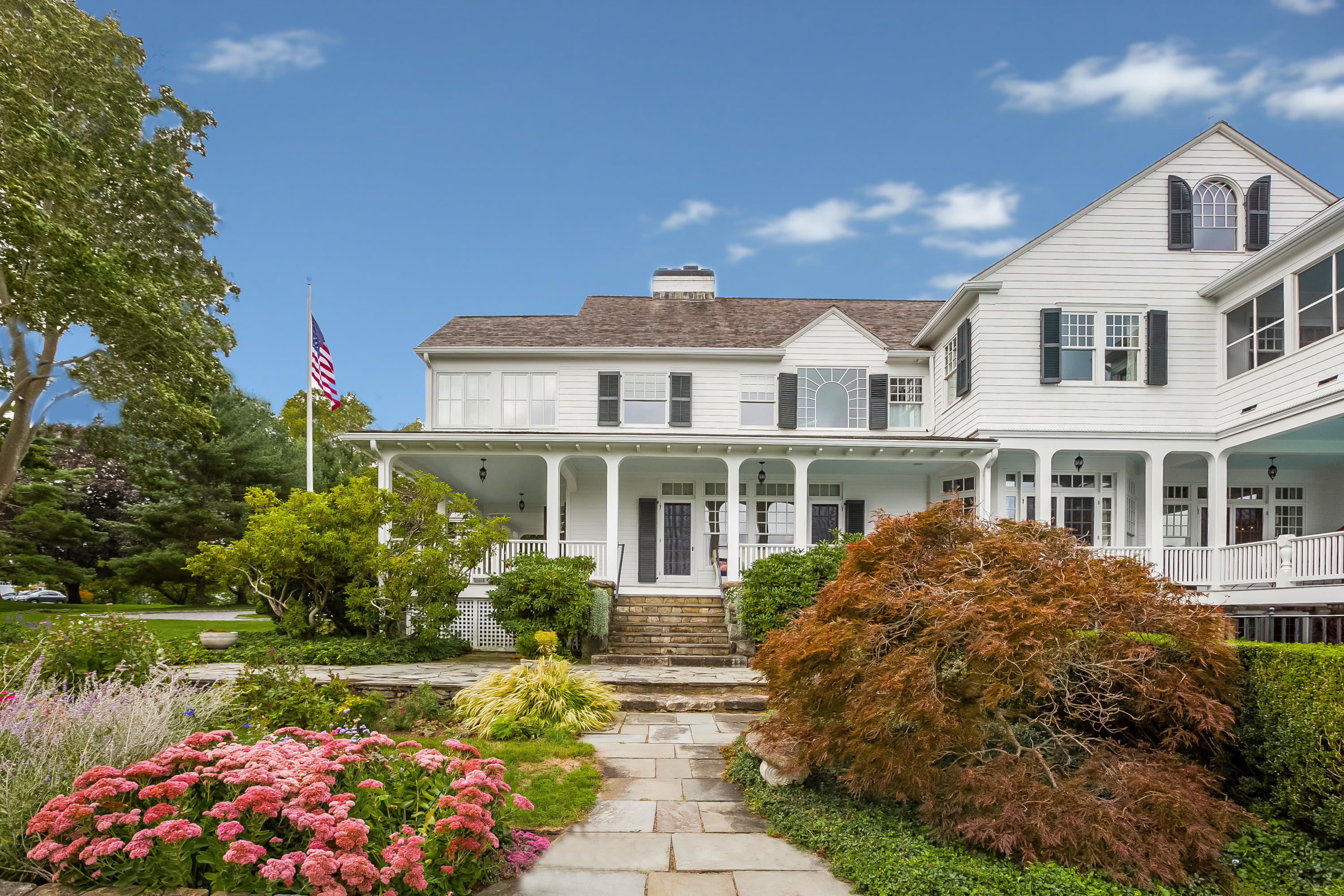 155 Long Neck Point Road Darien, CT 06820 - Photo 34 of 52 a front view of a house with garden
