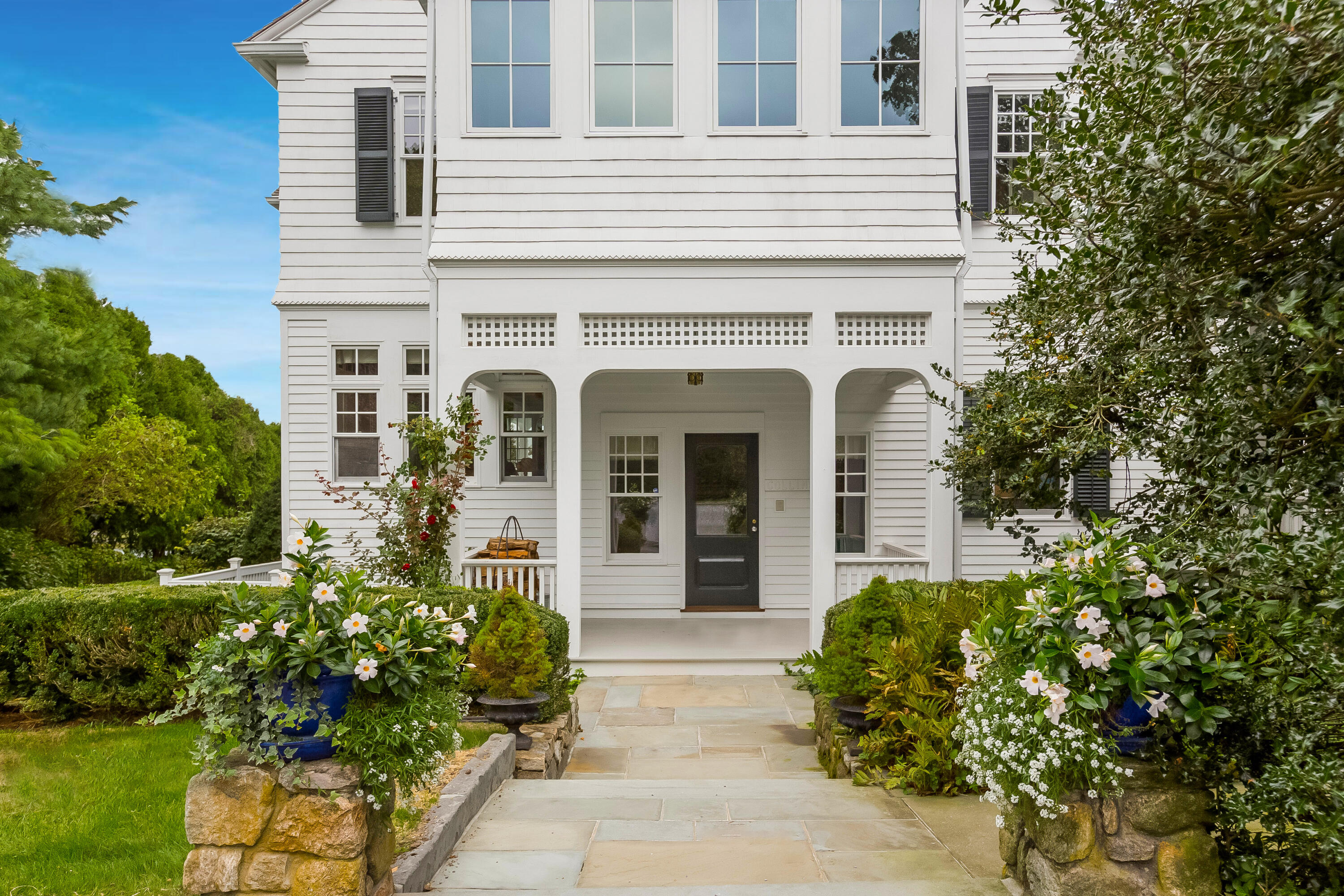 155 Long Neck Point Road Darien, CT 06820 - Photo 7 of 52 front view of a house with a yard