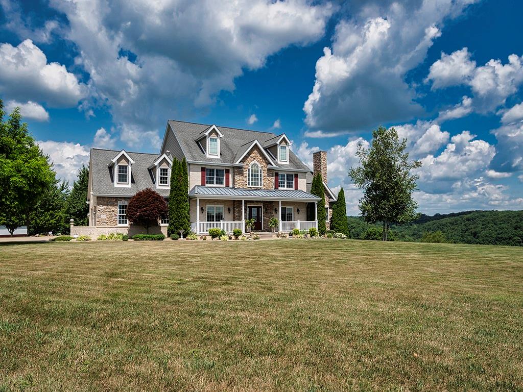 245 Reibold Road Renfrew, PA 16053 - Photo 1 of 25 a front view of a house with a big yard and large tree