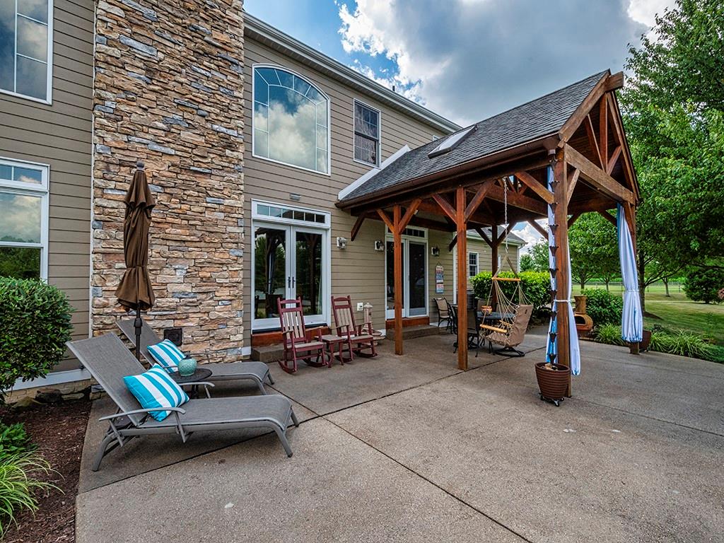 245 Reibold Road Renfrew, PA 16053 - Photo 19 of 25 a view of a patio with chairs and a table and chairs under an umbrella