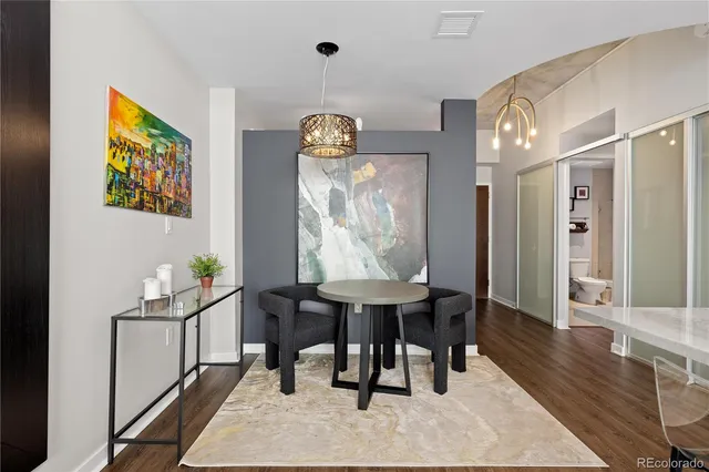 a view of a dining room with furniture and a chandelier