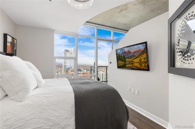 a bedroom with a bed and a painting on the wall