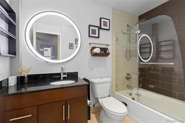 a bathroom with a toilet a sink and a mirror