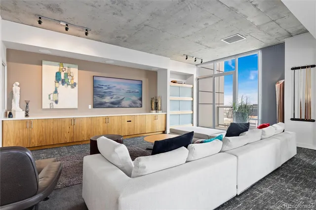 a room with furniture pool table and flat screen tv