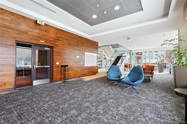 a view of kitchen with stainless steel appliances dining table chairs and sink