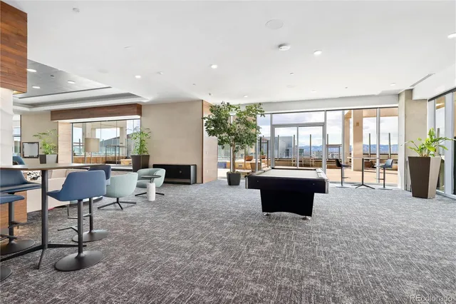 a living room with furniture a flat screen tv and chairs