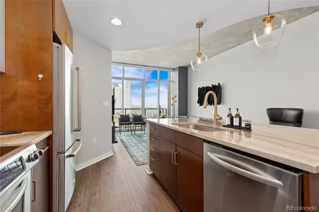 a kitchen with a sink appliances and cabinets