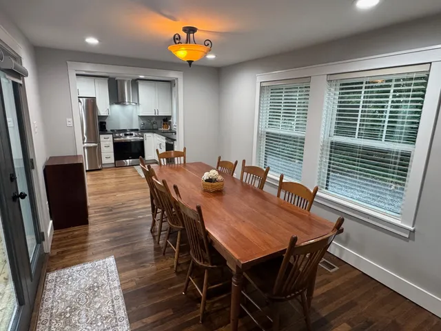 a view of a dining room with furniture and window